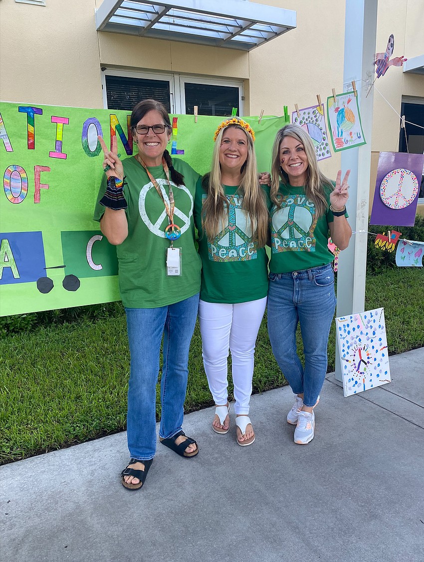 Gilbert W. McNeal Elementary School teachers Gwyn Ingham, Kristi Dyer and Ashlie Fulmer celebrate Peace Day with their classes. Each class read 