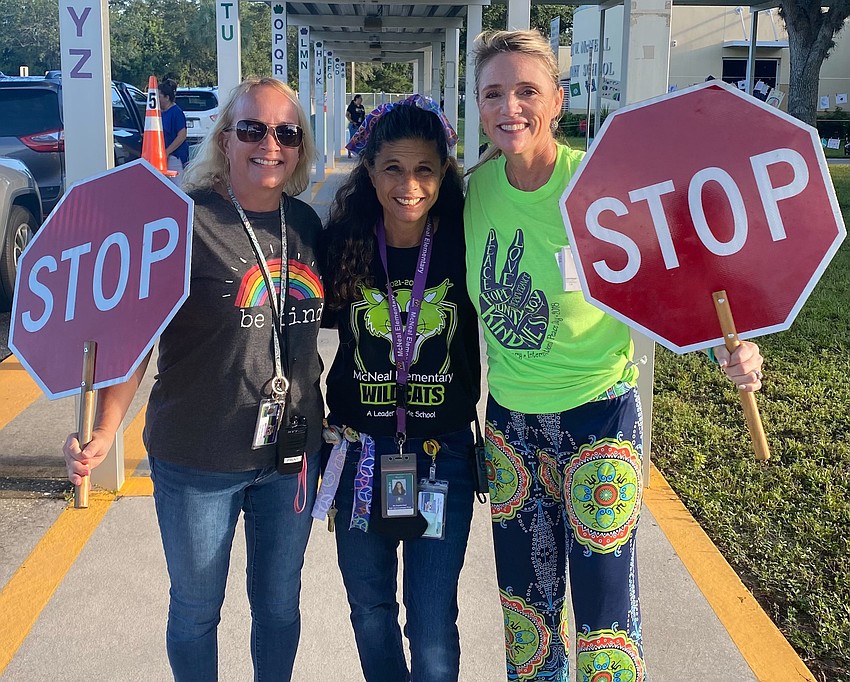 Paraprofessionals Mandy Frint and Jo Dapello-Gnad and Dana Townson, an Investing in Educational Excellence teacher, welcome students to school on Peace Day. Courtesy photo.