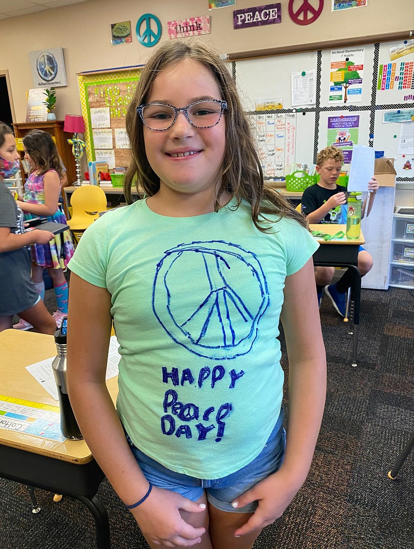 Fourth grader Eveyln Ridgney makes her own peace sign shirt for Peace Day. Courtesy photo.