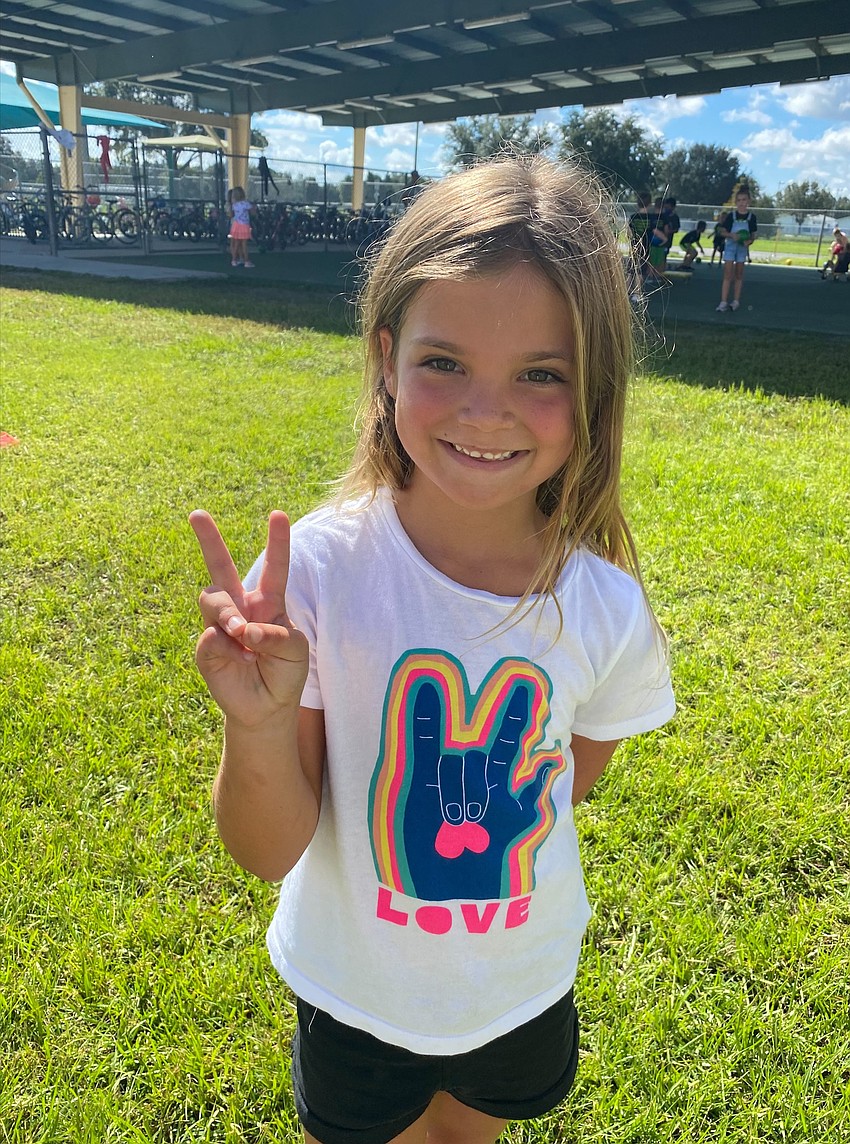 First grader Devon McFarland makes a peace sign for Peace Day. Courtesy photo.