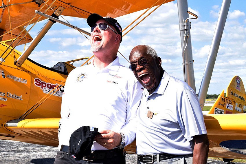 Darryl Fisher, the founder, president and pilot for Dream Flights, and Melvin Pettis, a Cypress Springs Gracious Retirement Living resident and veteran, laugh together after their flight.