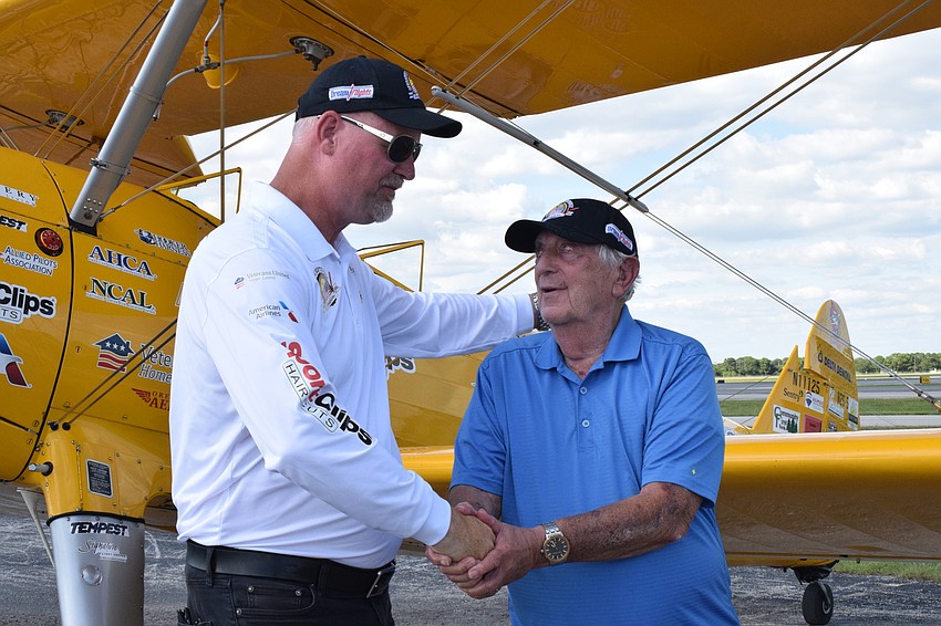 Darryl Fisher, the founder, president and pilot for Dream Flights, shakes hands with Joe Abrams, who's a Cypress Springs Gracious Retirement Living resident and Army veteran, as Abrams thanks him for the flight.