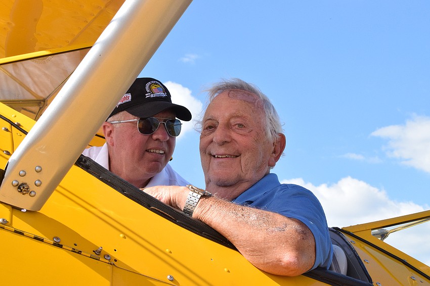 John Swan with Dream Flights straps Joe Abrams, a Cypress Springs Gracious Retirement Living resident and Korean War veteran, into the Spirit of Wisconsin, which is a nine-cylinder Stearman open cockpit biplane.