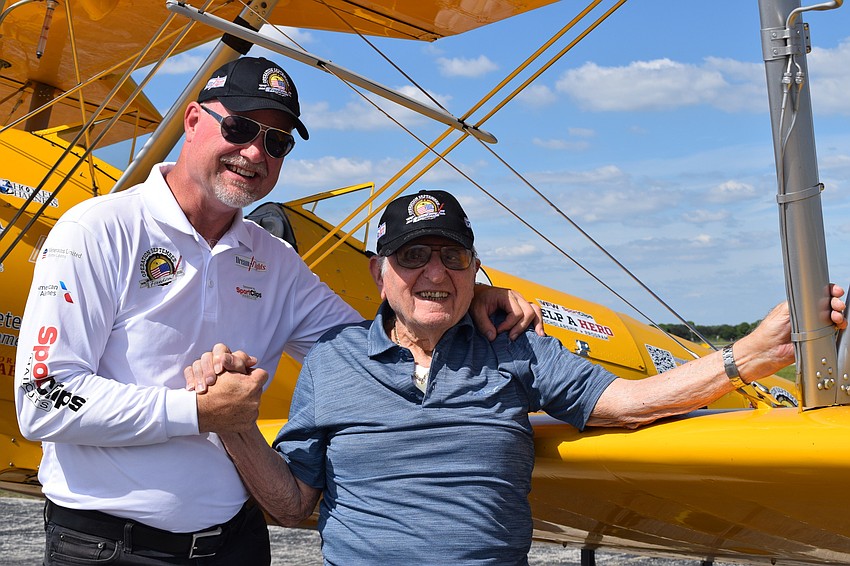 Darryl Fisher, the founder, president and pilot for Dream Flight, gives Chip Tominelli, a Cypress Springs Gracious Retirement Living resident and World War II veteran, a Dream Flights hat to commemorate their trip in the sky.