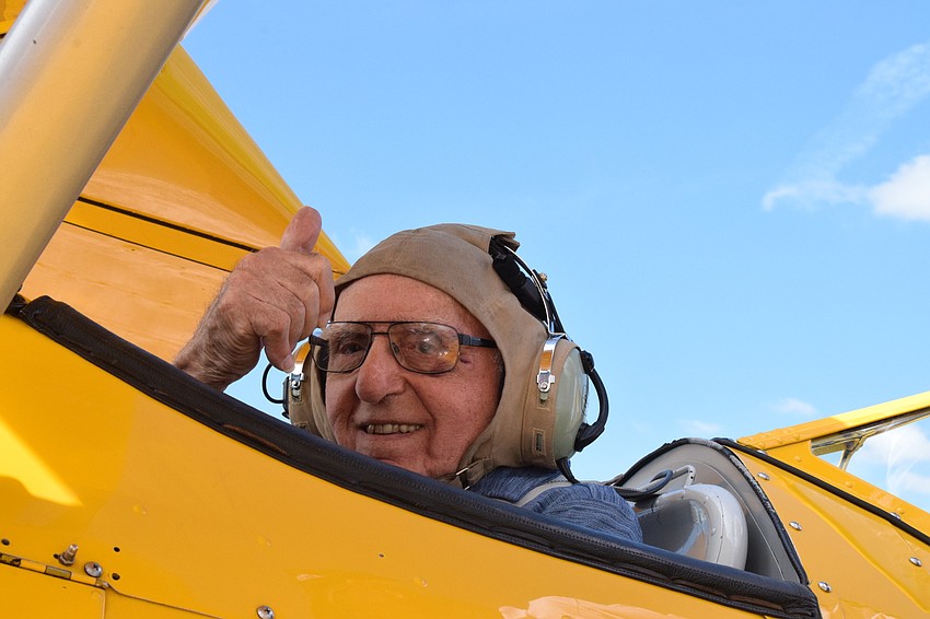 Chip Tominelli, who is a Cypress Springs Gracious Retirement Living resident and World War II veteran, gives a smile and a thumbs up before he takes off in the Spirit of Wisconsin, a Boeing-Stearman biplane built in 1943.