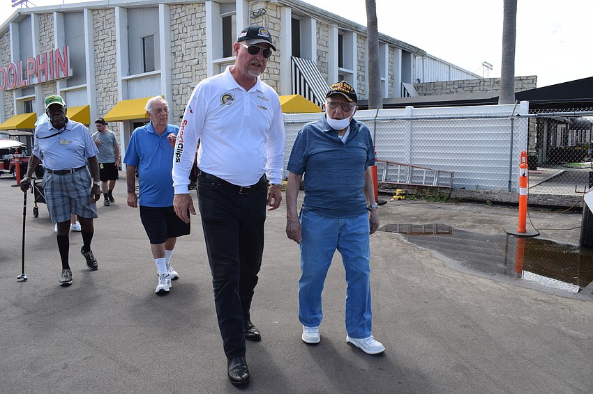 Cypress Springs Gracious Retirement Living residents Melvin Pettis and Joe Abrams follow Darryl Fisher, the founder, president and pilot for Dream Flights, and fellow Cypress Springs resident Chip Tominelli to the plane.