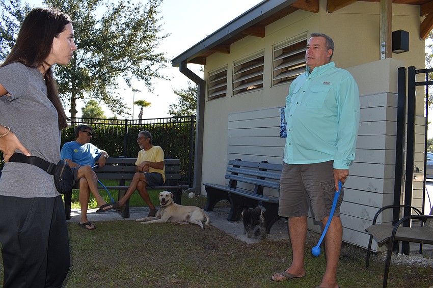 Fannie Bushin and Peter Larson chat Friday morning at Bayfront Park's dog park.