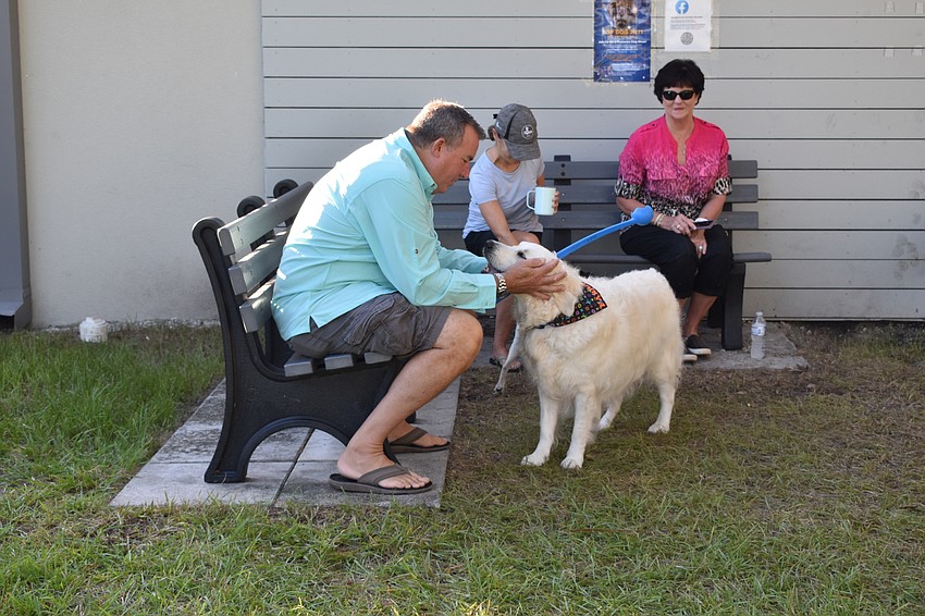 Peter Larson plays with Dick Lyons' Farrah Fawcett on Friday morning.