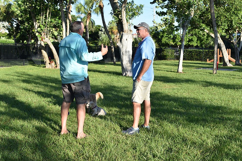 Peter Larson and Dick Lyons chat Friday morning at Bayfront Park's dog park.
