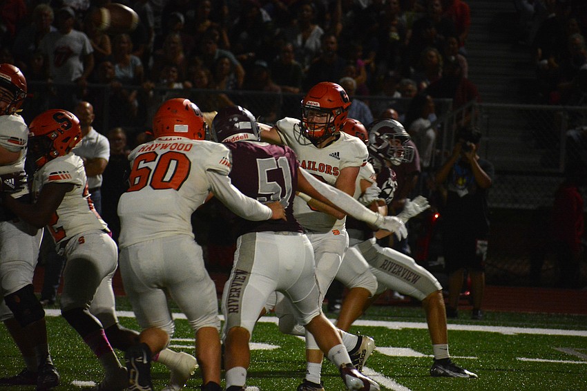 Sarasota quarterback Lance Trippel fires a pass to his left before the Rams pass rush gets to him.