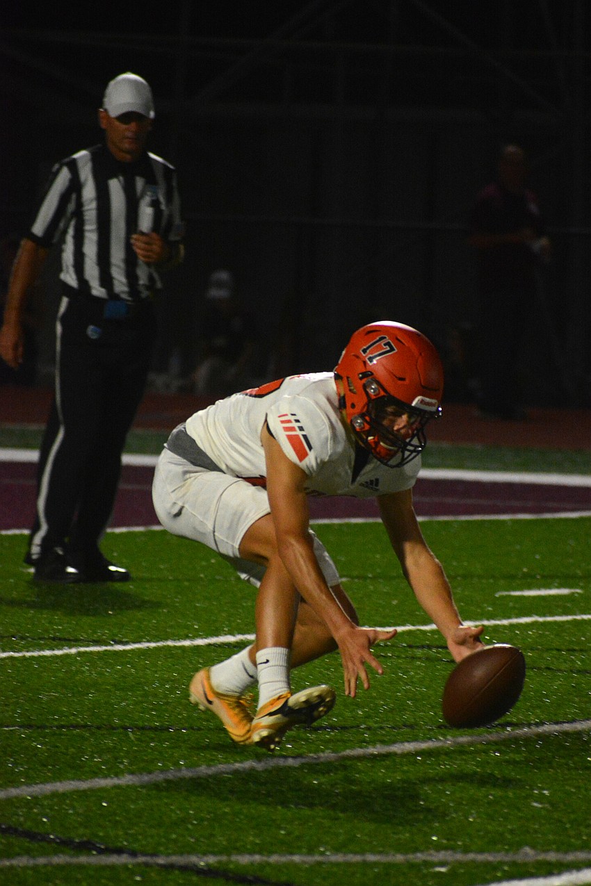 Sarasota punter Andrew Clayton falls on a low snap.