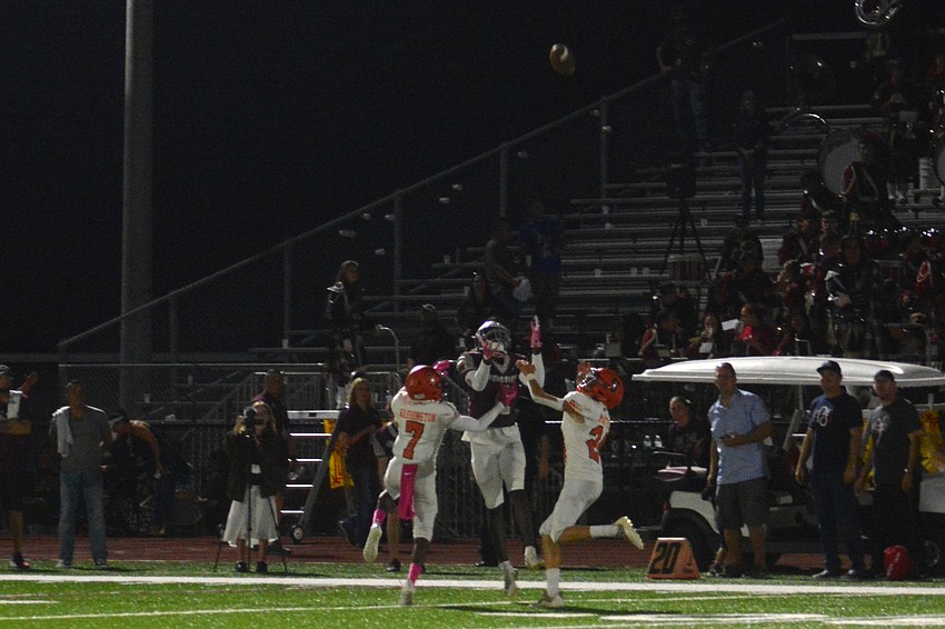Riverview wide receiver Jaron Glover, middle, goes up against two Sailors for a jump ball. Glover would make the catch.