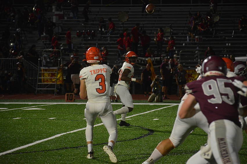 Sarasota quarterback Lance Trippel fires a swing pass to running back Jarmel Holloway.