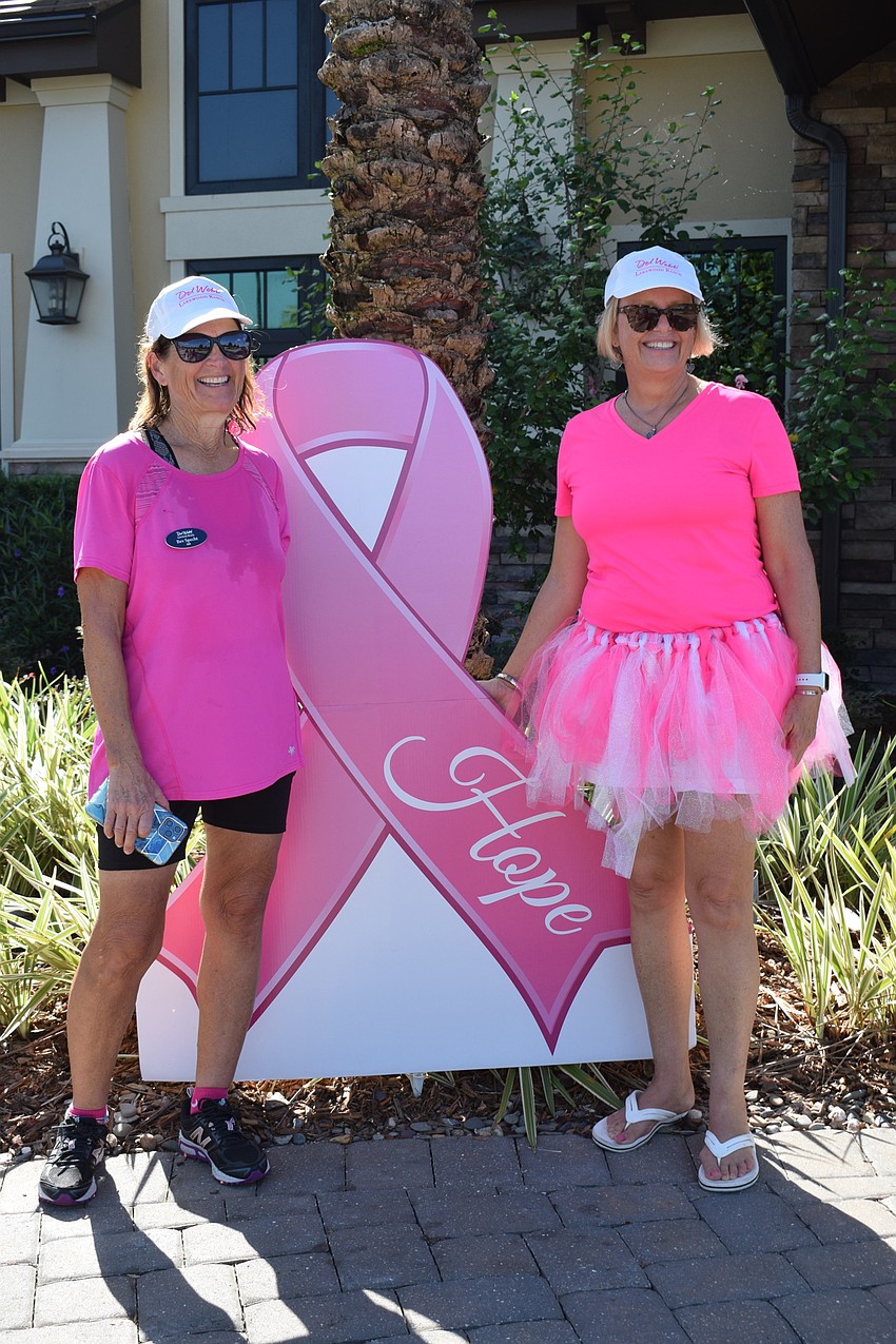 Del Webb's Bev Specht and Susan Batchelder celebrate finishing the walkathon.