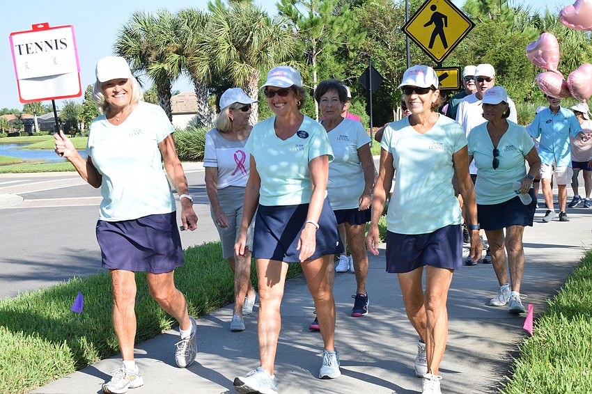 Chris Dolan, Laurel Platt and Carol Sampson lead the Del Webb tennis group as they start the walkathon.