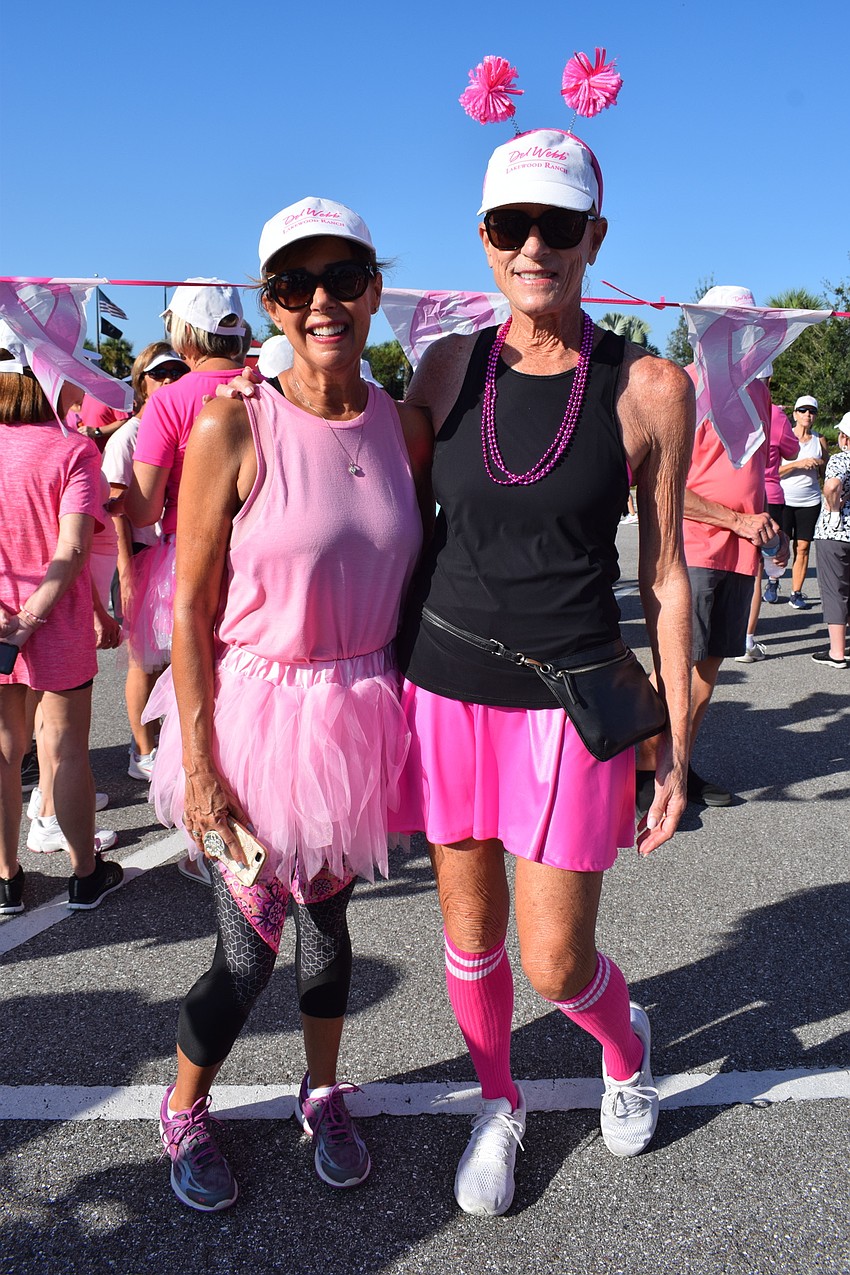 Del Webb's Debbie Stoner and Esplanade's Lindy Foster get decked out in pink for the walkathon.