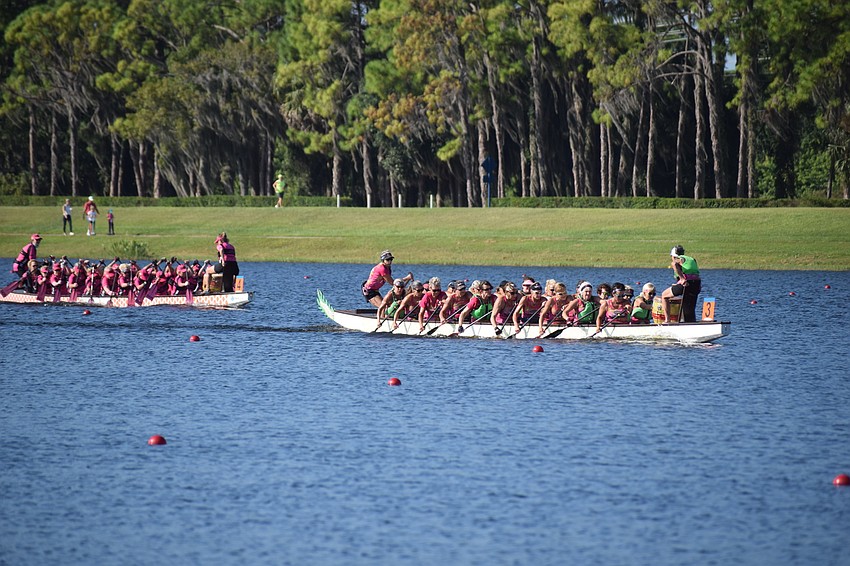 Survivors in Sync pulls away from second-place Save Our Sisters in a 500-meter race at Nathan Benderson Park on Saturday.