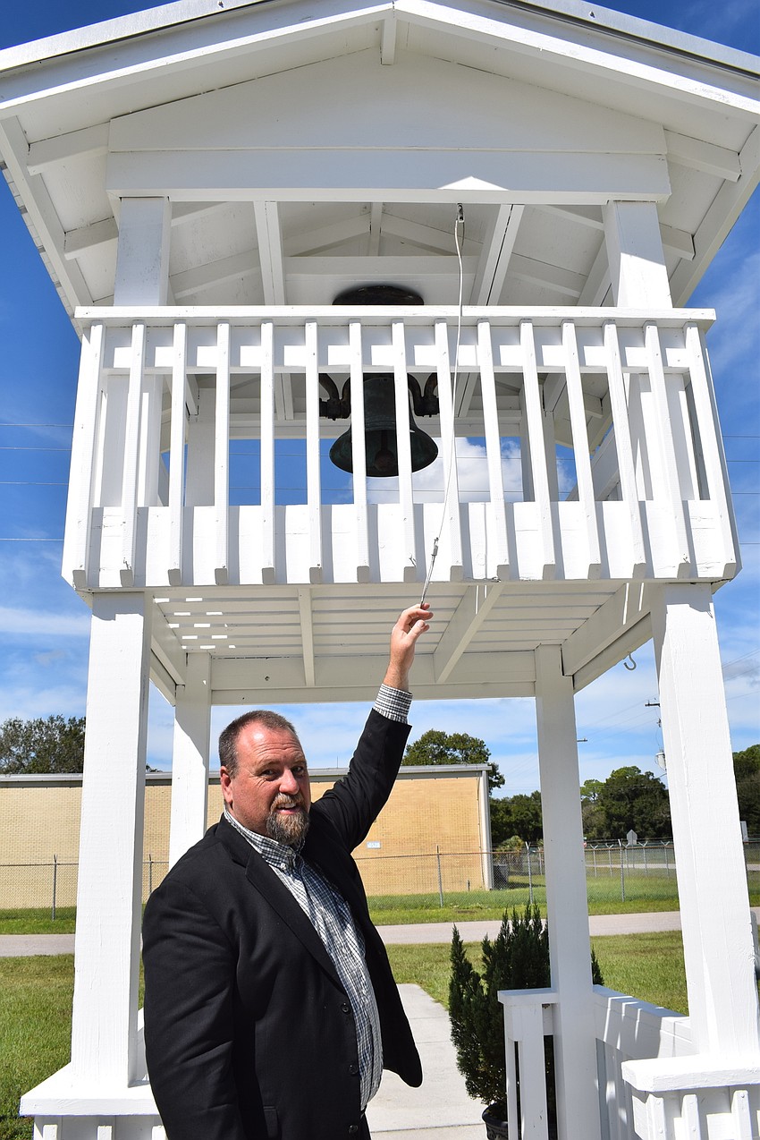 Pastor Mathew Curley rings the bell for services.