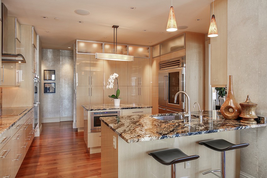 The kitchen is arrayed with  wood flooring, granite countertops and top-of-the-line appliances.
