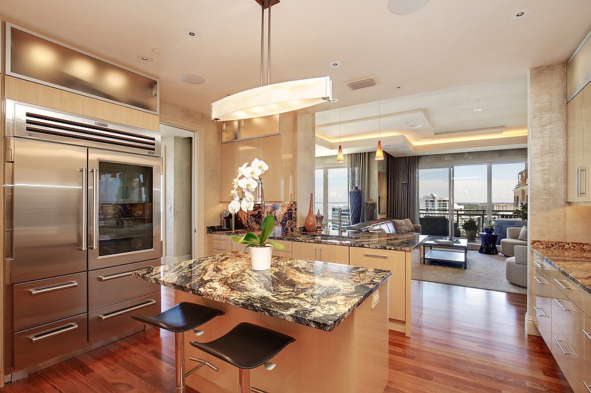 The kitchen is arrayed with  wood flooring, granite countertops and top-of-the-line appliances.