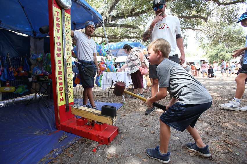 Lee Lester swings hard with a hammer.