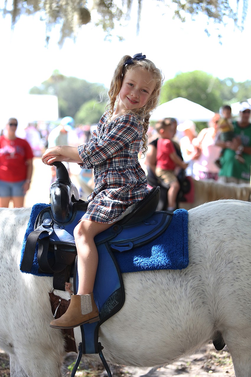 Ivy Betensky rides a pony.
