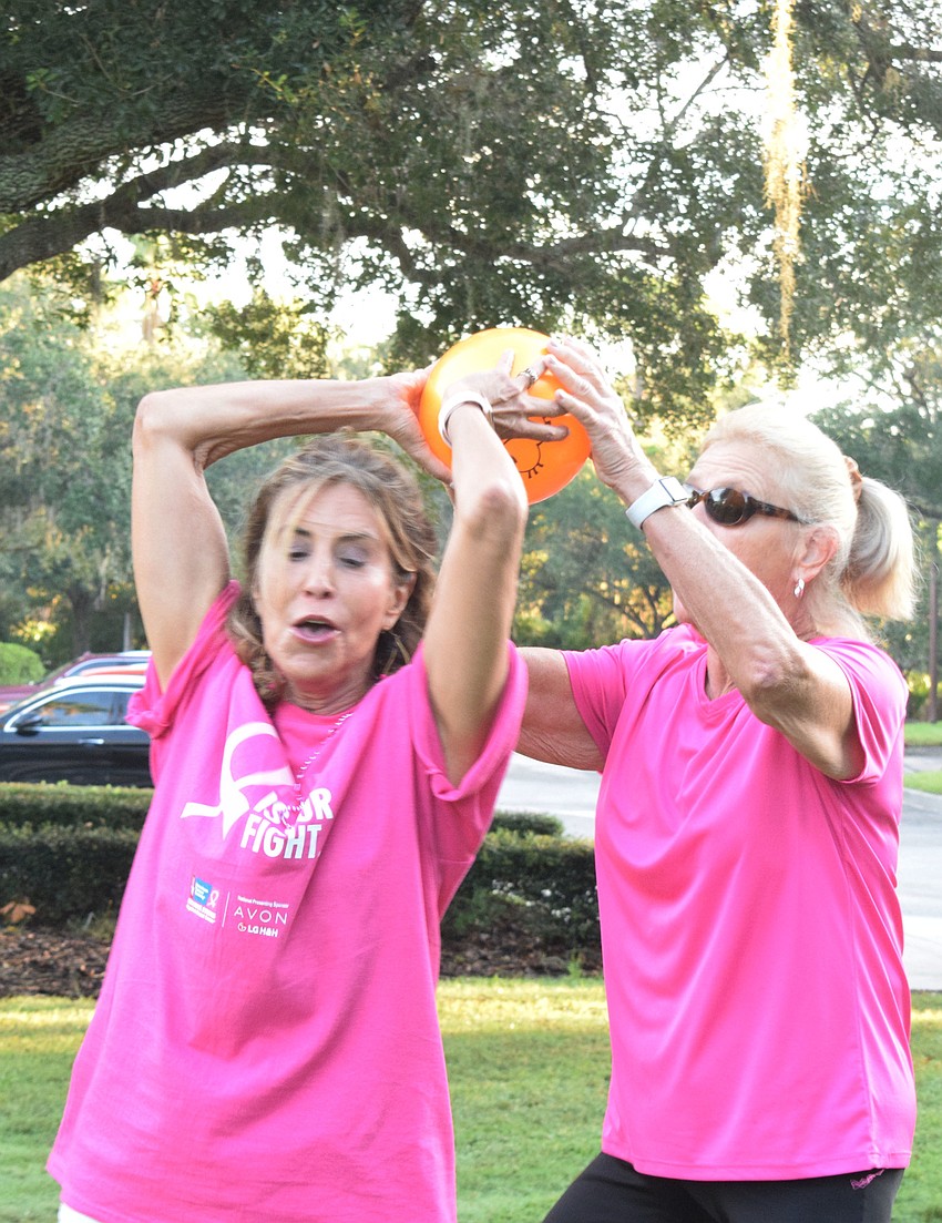 Gail Snyder passes a ball overhead to Debbie Gatlin.