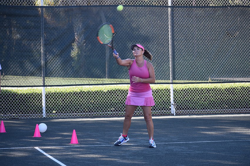 Kelly Reeve uses a forehand stroke to try to earn points for the tennis competition.
