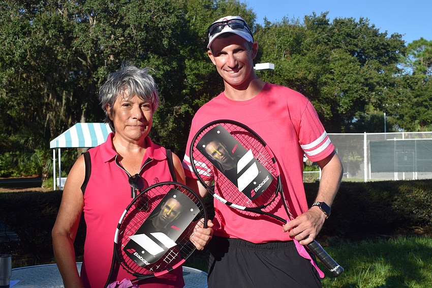 Barbara Somma, who is a co-chair of University Park Country Club's Pink Week, and Joe Lissi, the director of tennis and fitness, are ready for the tennis competition, which had 32 participants.