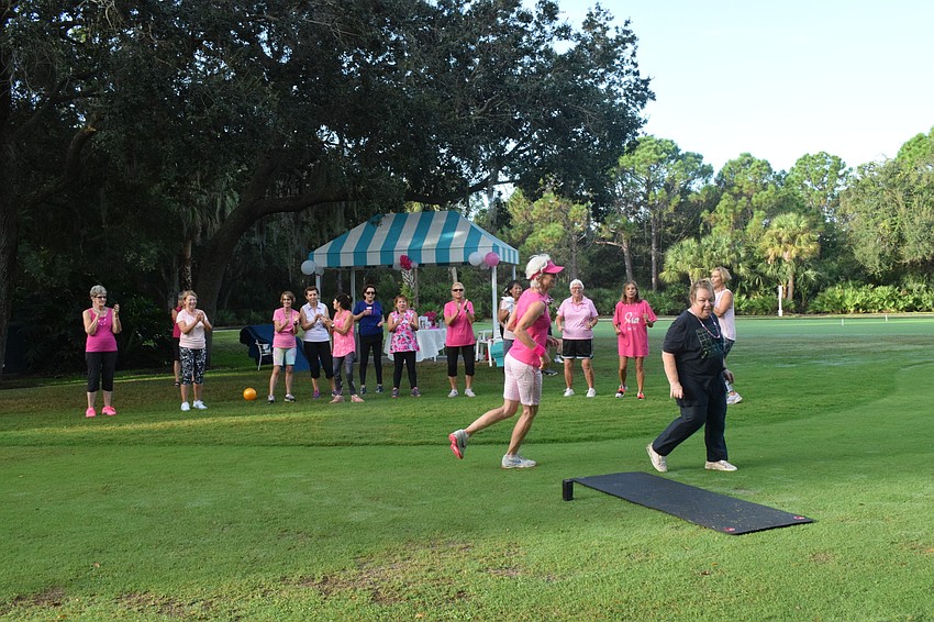 Residents watch as Ursula Ruckli competes against Ellen Rothbaum for the final mat in musical squats during the fitness boot camp.