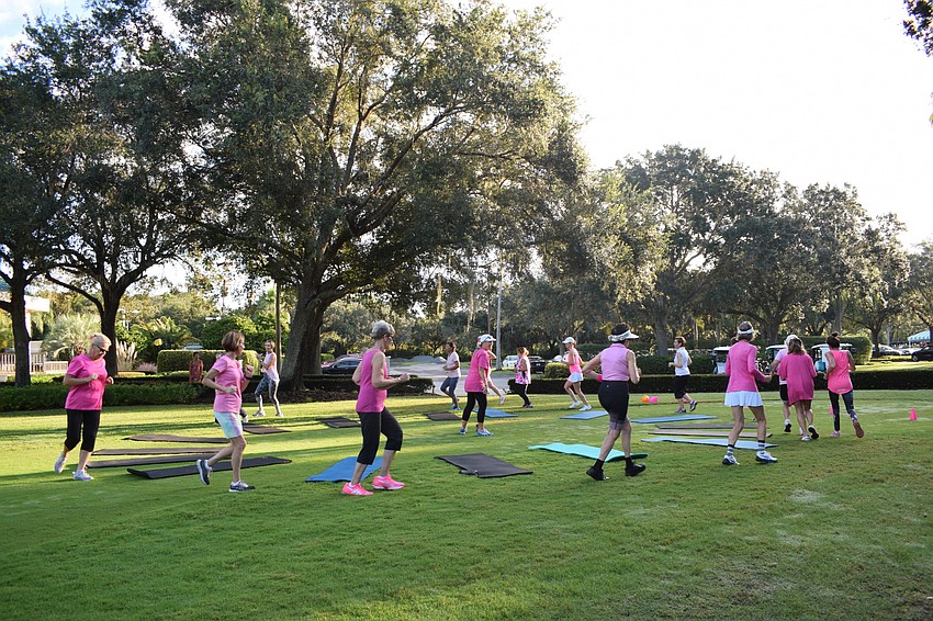 Fitness boot camp participants run around a circle of mats as music plays during musical squats. This year was the first year the fitness boot camp included musical squats.