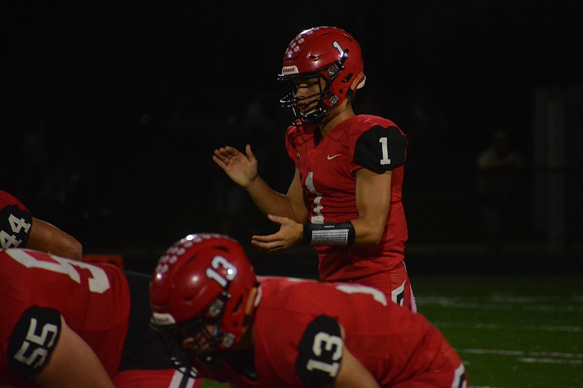 Mooney senior quarterback Tayven Clark calls for the snap.