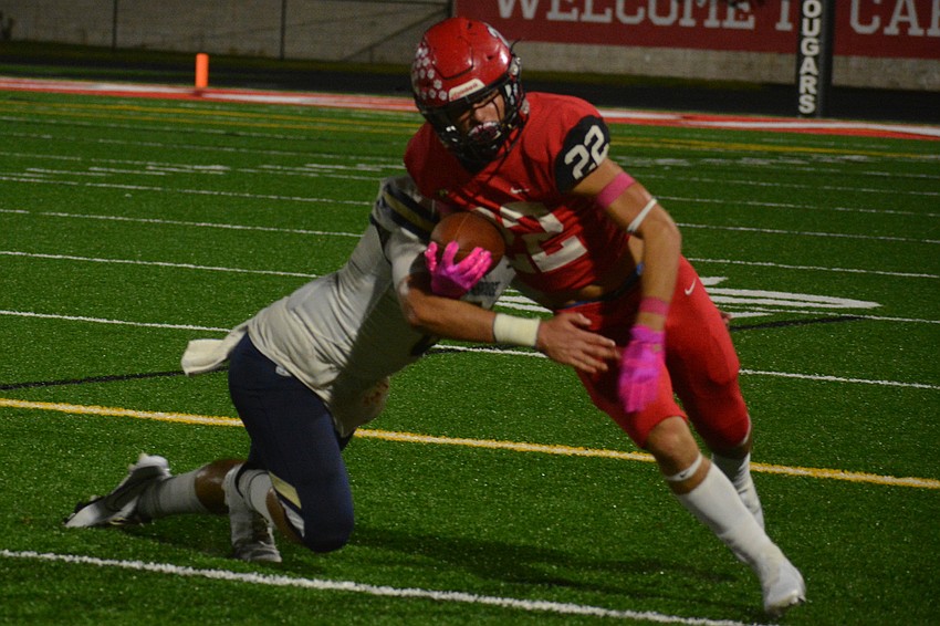 Mooney sophomore running back Carson Beach evades a tackler.