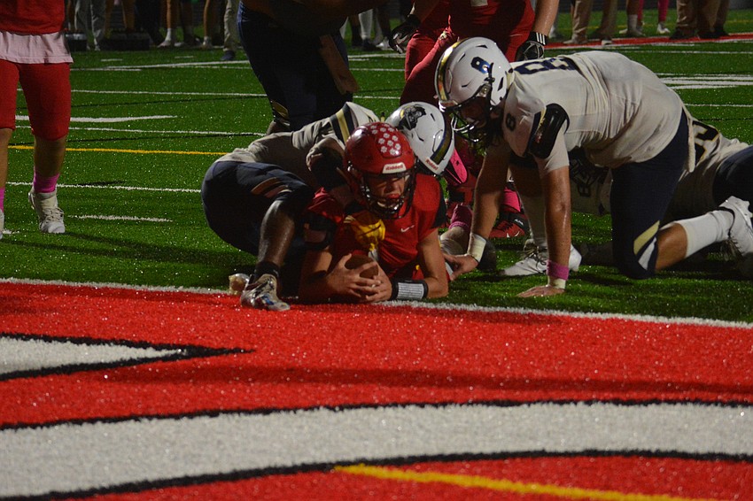 Tayven Clark lands over the goal line for a touchdown.