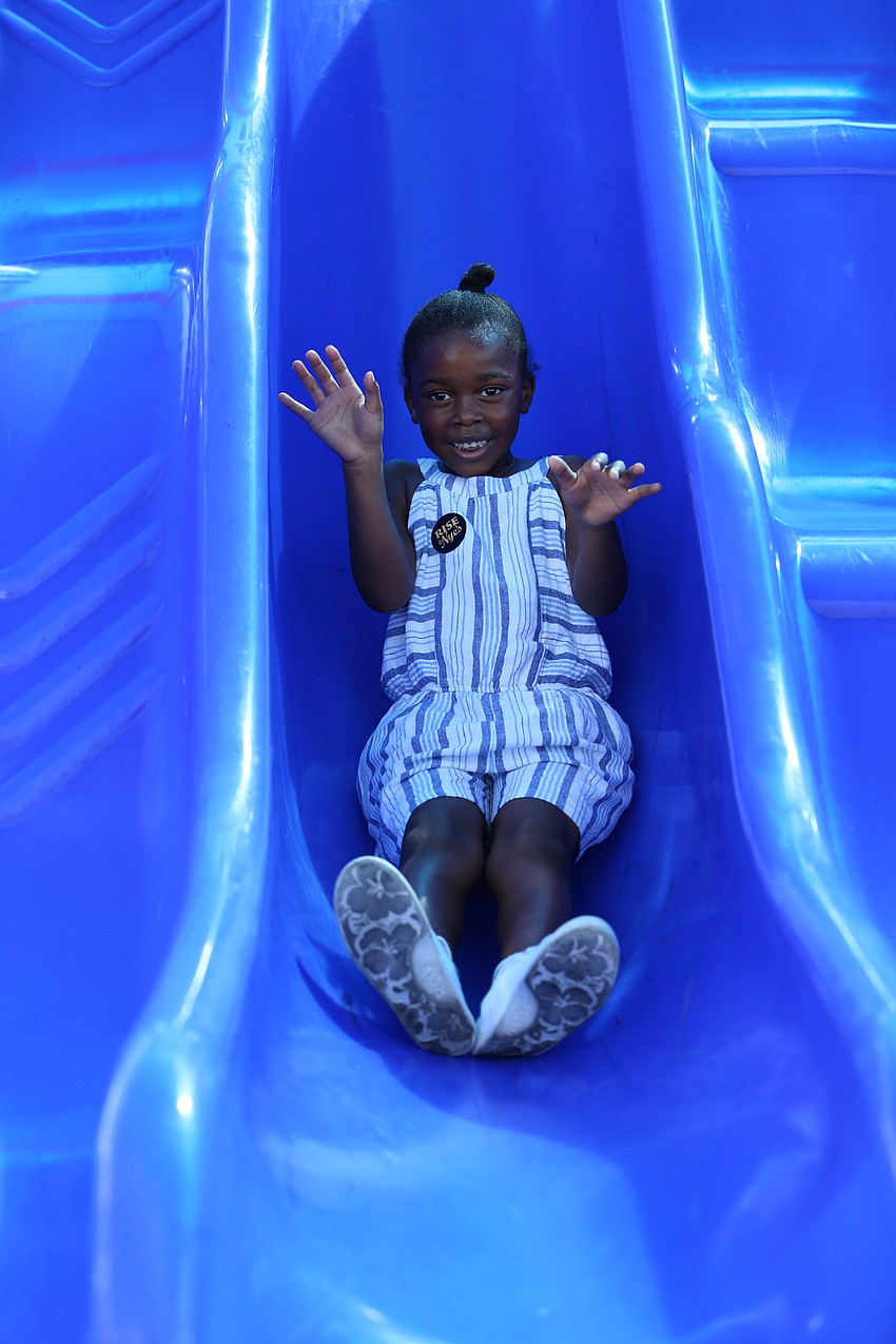 Mia Rumph goes down the slide.