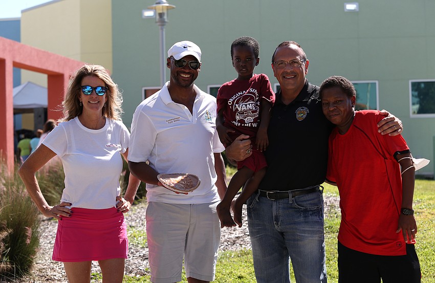 Elizabeth Moore, Commisioner Kyle Battie, Ramir Newsome, Chief of Police Rex Troche and Shay Newsome