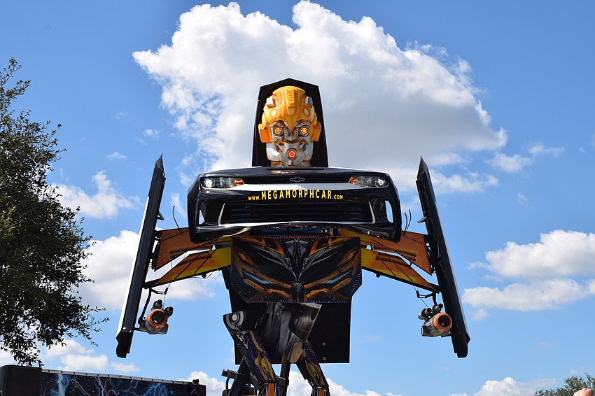 Megamorph transforms from a police car into a transformer astonishing audience members.