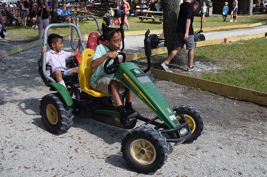 St. Petersburg's Camilo Nieves-Bedaya, 5, lets his 8-year-old brother, Alejandro Nieves-Bedaya, do all the work during a ride.