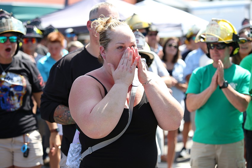 Erica Pickett fights back tears as her children are cheered on.