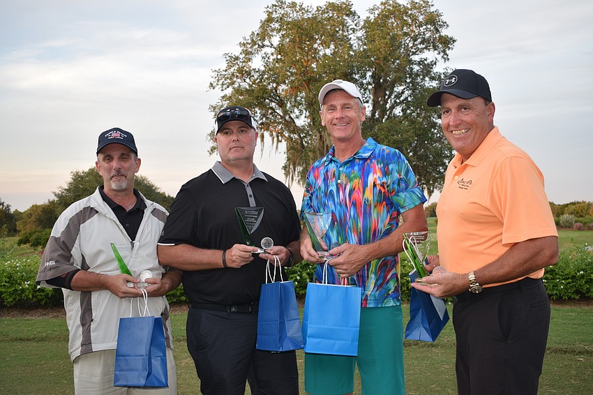 Lakewood Ranch's Chris Benevento, Chris Tennant, Rick Reid and Mark Pascarella celebrating winning the golf tournament.