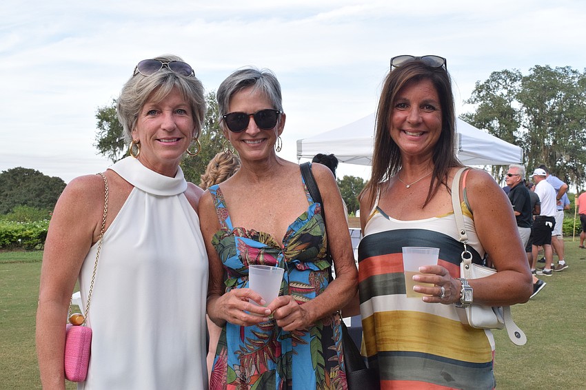 Lakewood Ranch's Beth Potere, Joni Fielding and Michele Caba have fun at Putts for Mutts after participating in the pickleball tournament. 