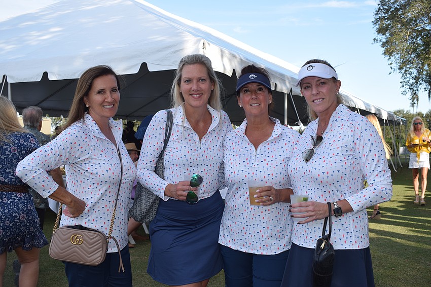 Lakewood Ranch's Iolanda Goodfellow, Lora Rees, Heidi Rittenhouse and Jackie Gehrisch are happy to meet dogs while at Putts Fore Mutts. 