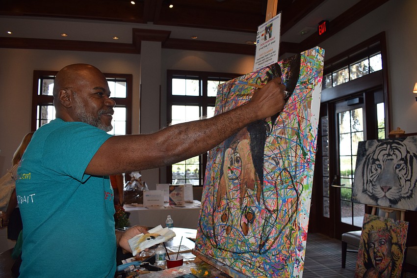 Sarasota's Tom Ruthz paints a dog upside down. The painting was later auctioned off to raise money for the Humane Society at Lakewood Ranch.
