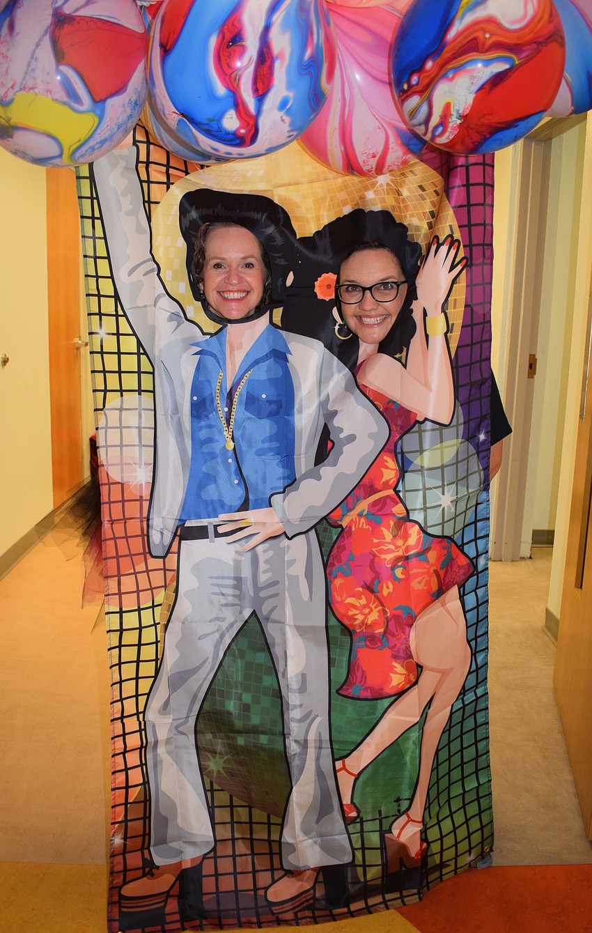 Tina Stancil, the assistant principal, and Courtney Walker, the curriculum coach and media specialist, take a photo as Tony Manero and Stephanie Mangano in 
