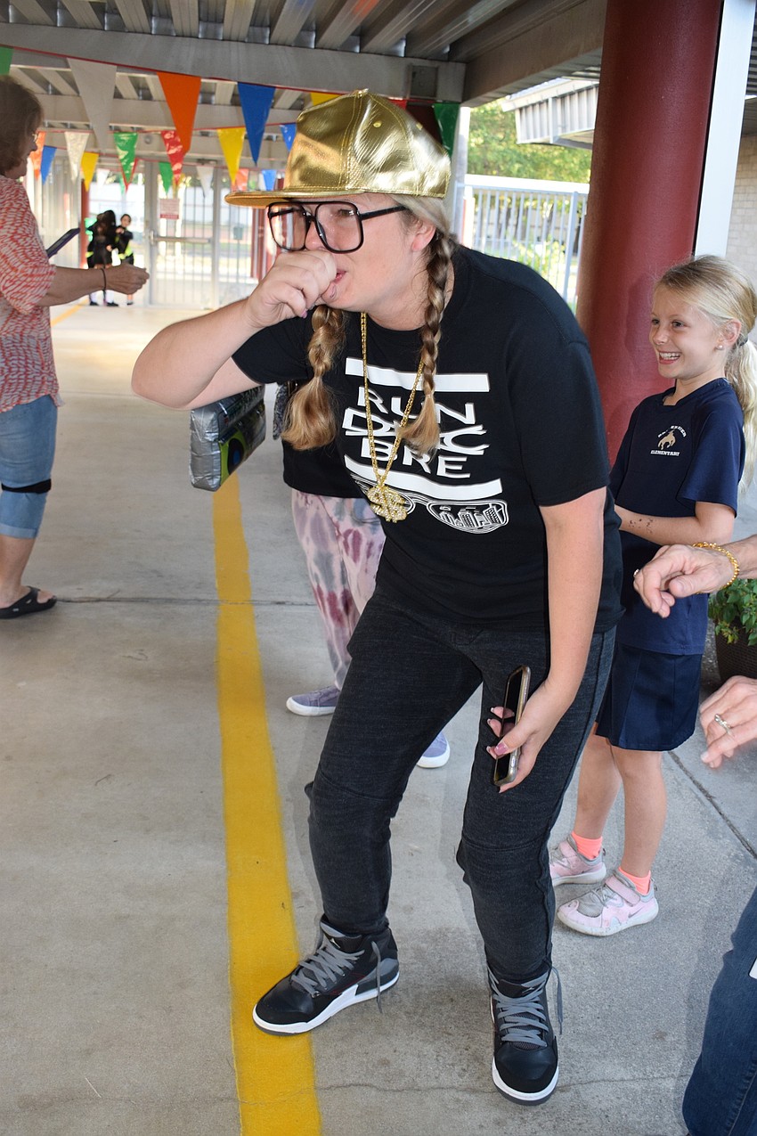 Tiffany Greer, a second grade teacher, beat boxes as students walk to class.