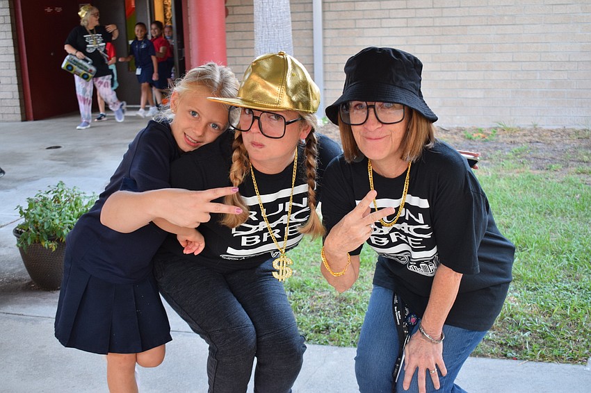 Paige Royce, a second grader, and Tiffany Greer and Pam Tabb, who are second grade teachers, are excited for Rock Our School Day.
