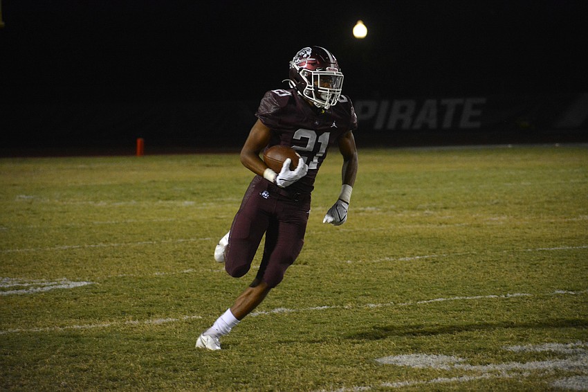 Pirates senior Nehemiah Jenkins turns up the field after catching a screen pass. Jenkins, usually a defensive back, has also been given running back duties after a string of injuries.