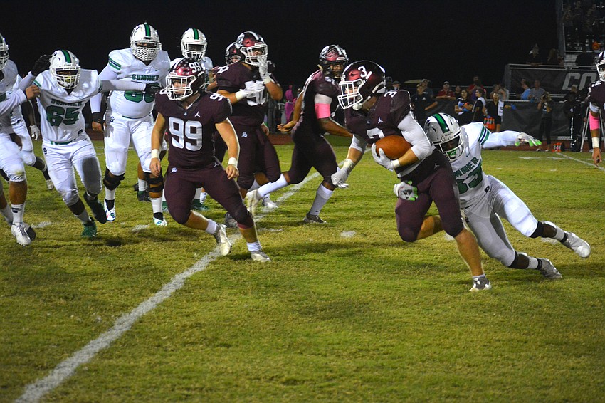Pirates junior Aidan Dangler (3) gets tackled after intercepting sophomore Sumner quarterback Greg Smith.