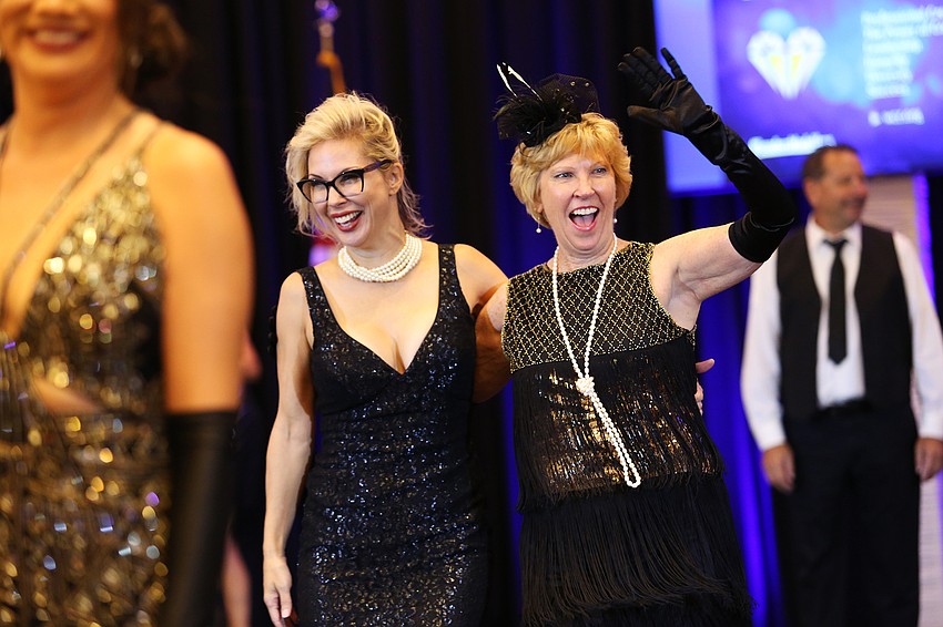 Karen Medford and Kathy Collums walk the runway.