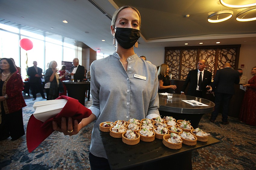 Kristen Henning serves up jerk chicken salad.